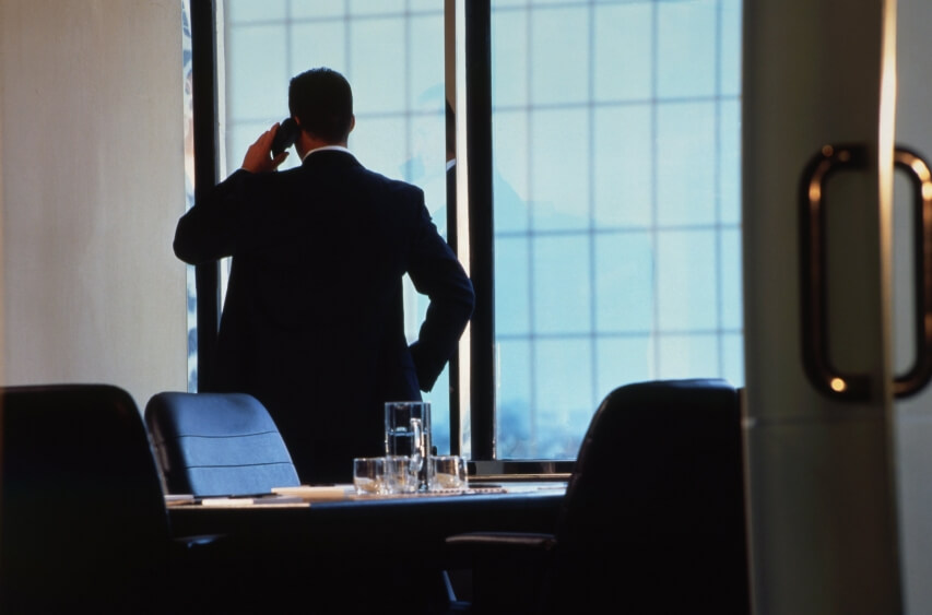 cloud based phone system man standing near a window